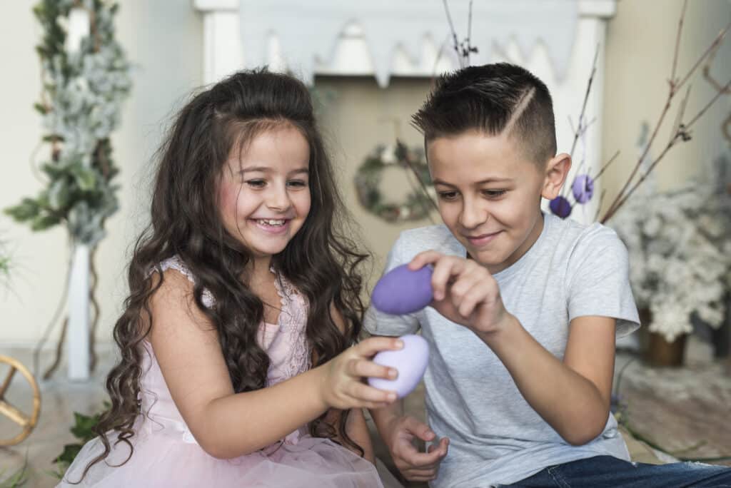 boy girl playing with easter eggs